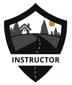 Shield-shaped emblem featuring a road leading to a house with surrounding trees. The sun is in the background. Text below reads "INSTRUCTOR." Color scheme includes black, gray, and yellow. Learn more in our "About Us" section.